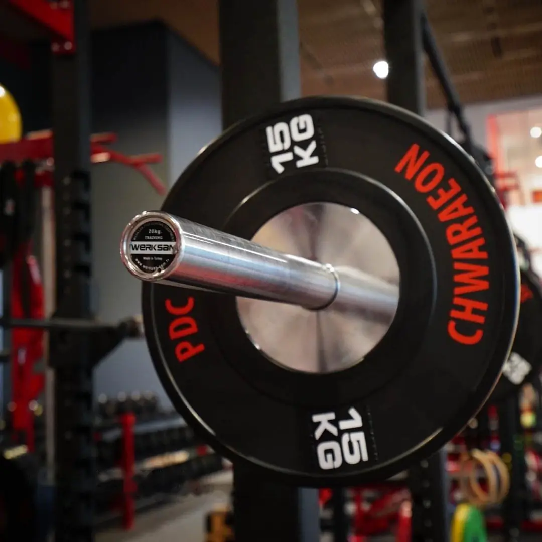 End cap of a Werksan 20 kg bar loaded with a bumper plate